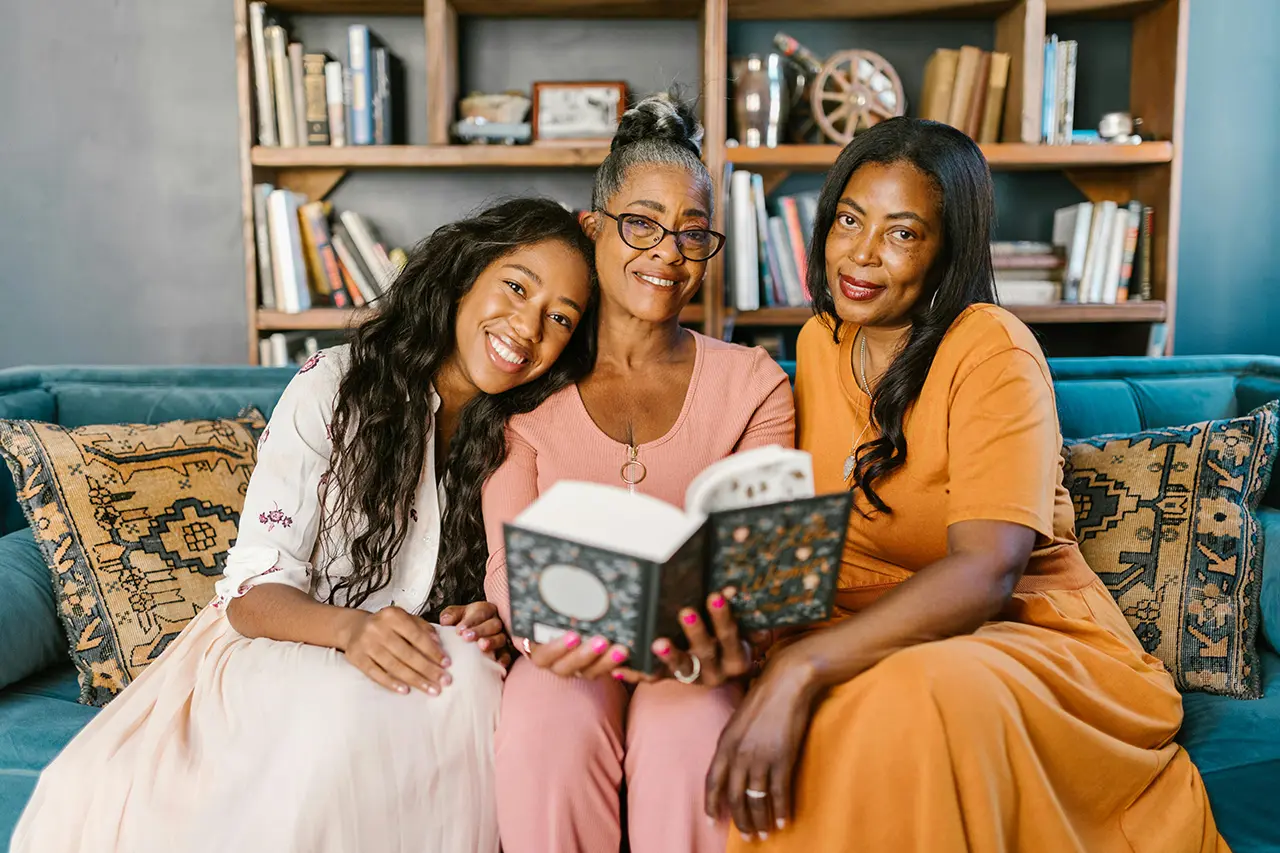 Three generations sharing a book at home